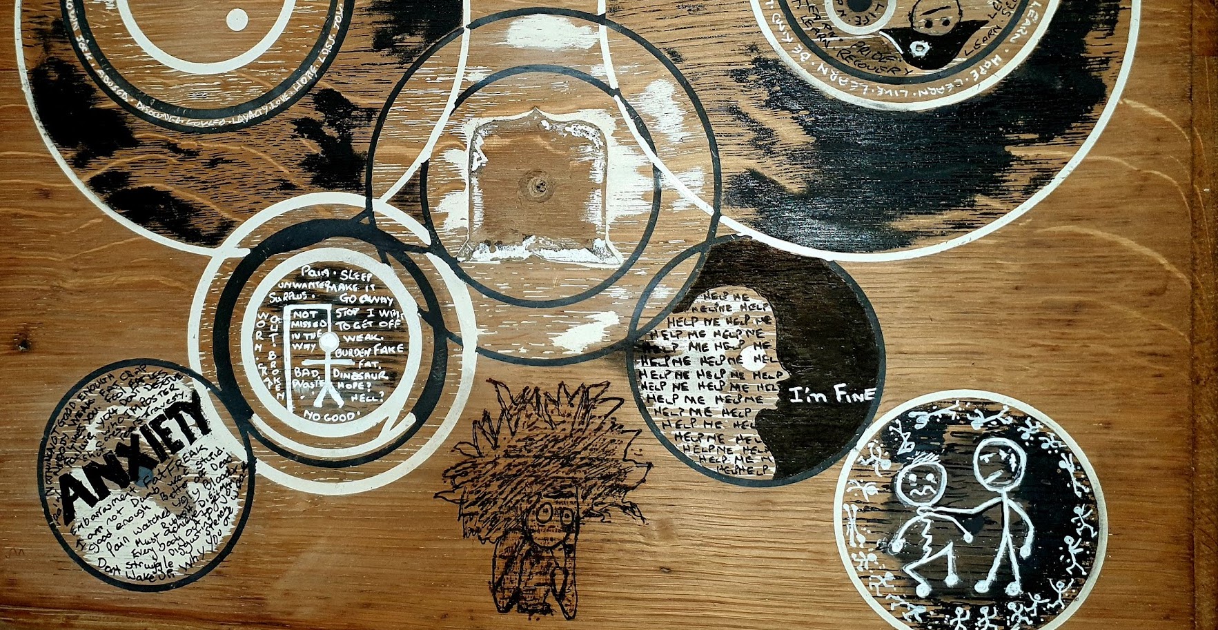 A piece of artwork on wood, created by a participant