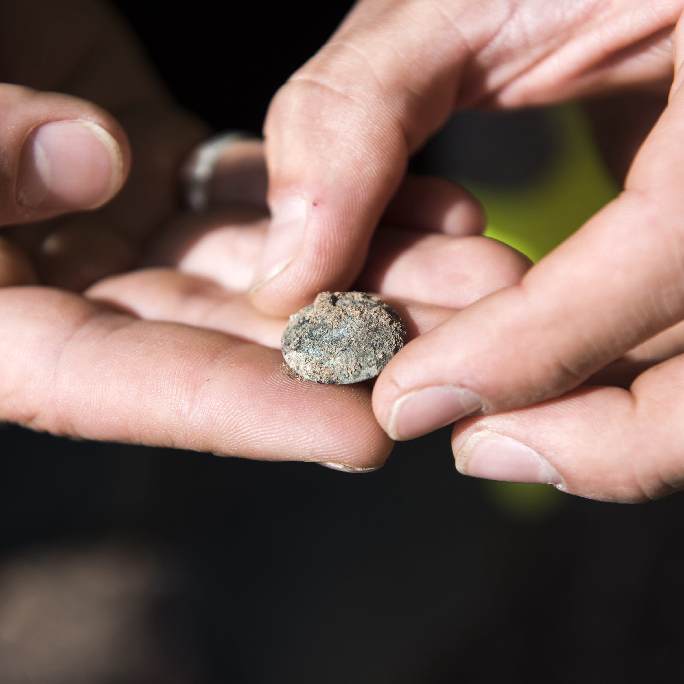A veteran holding a Scots Guard button discovered at Hougoumont