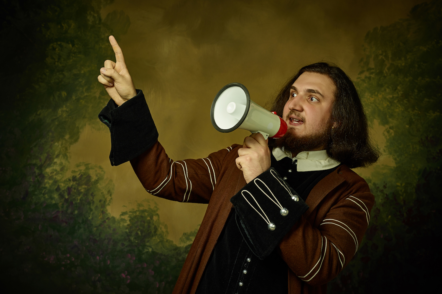 A man in Elizabethan clothes speaking into a megaphone